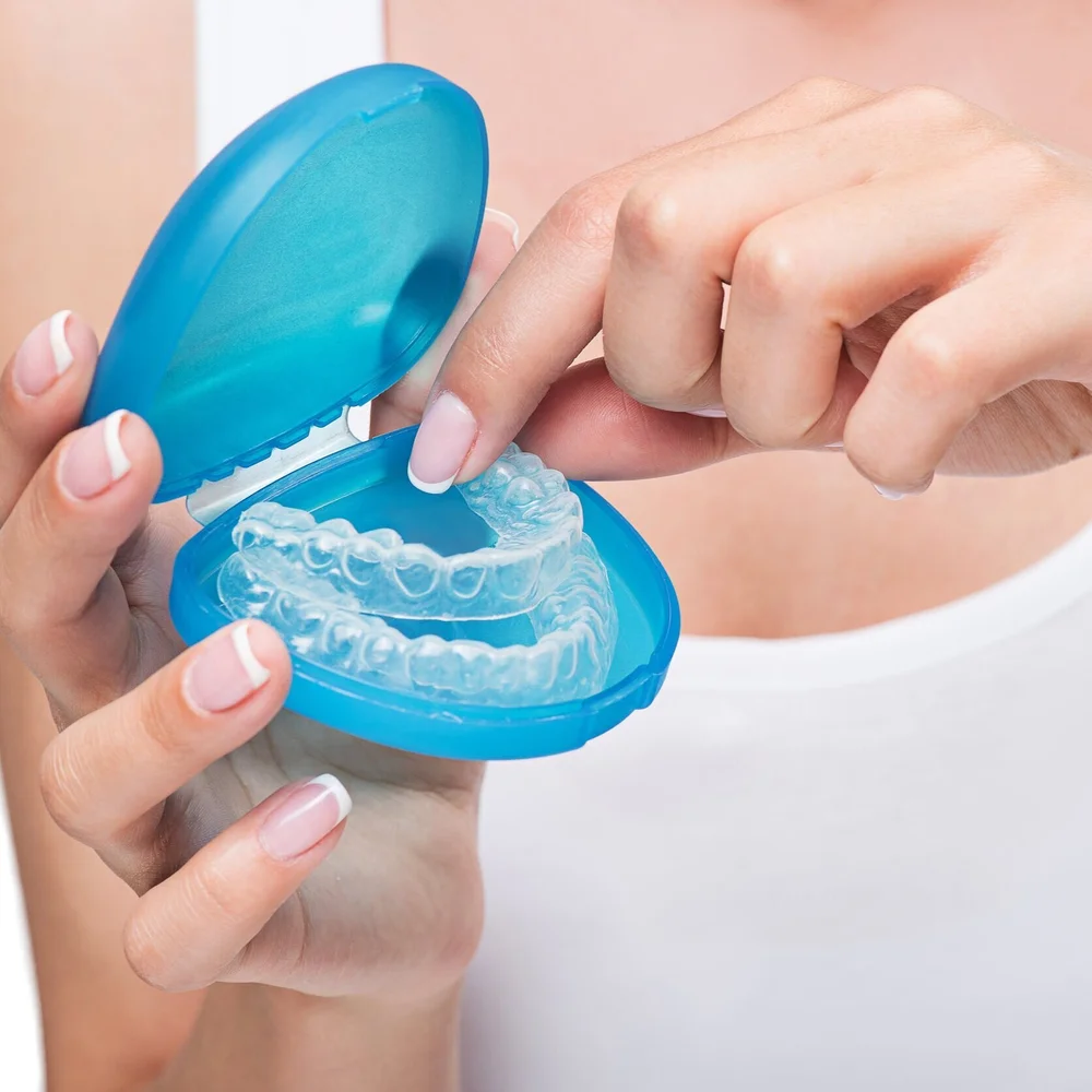 clear dental aligner trays in a blue case